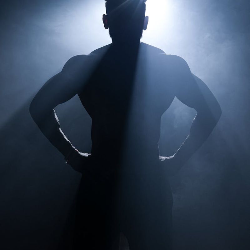 Athlete in a powerful pose, showing strength and stability, with dramatic lighting.
